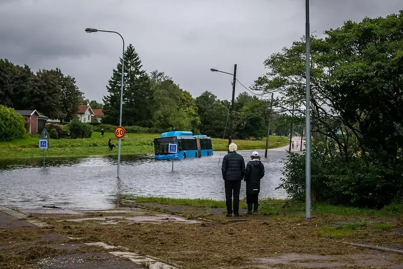 Ett äldre par tittar på en översvämmad gata